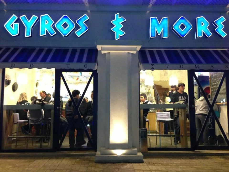 Gyros and More restaurant with a lit blue sign
