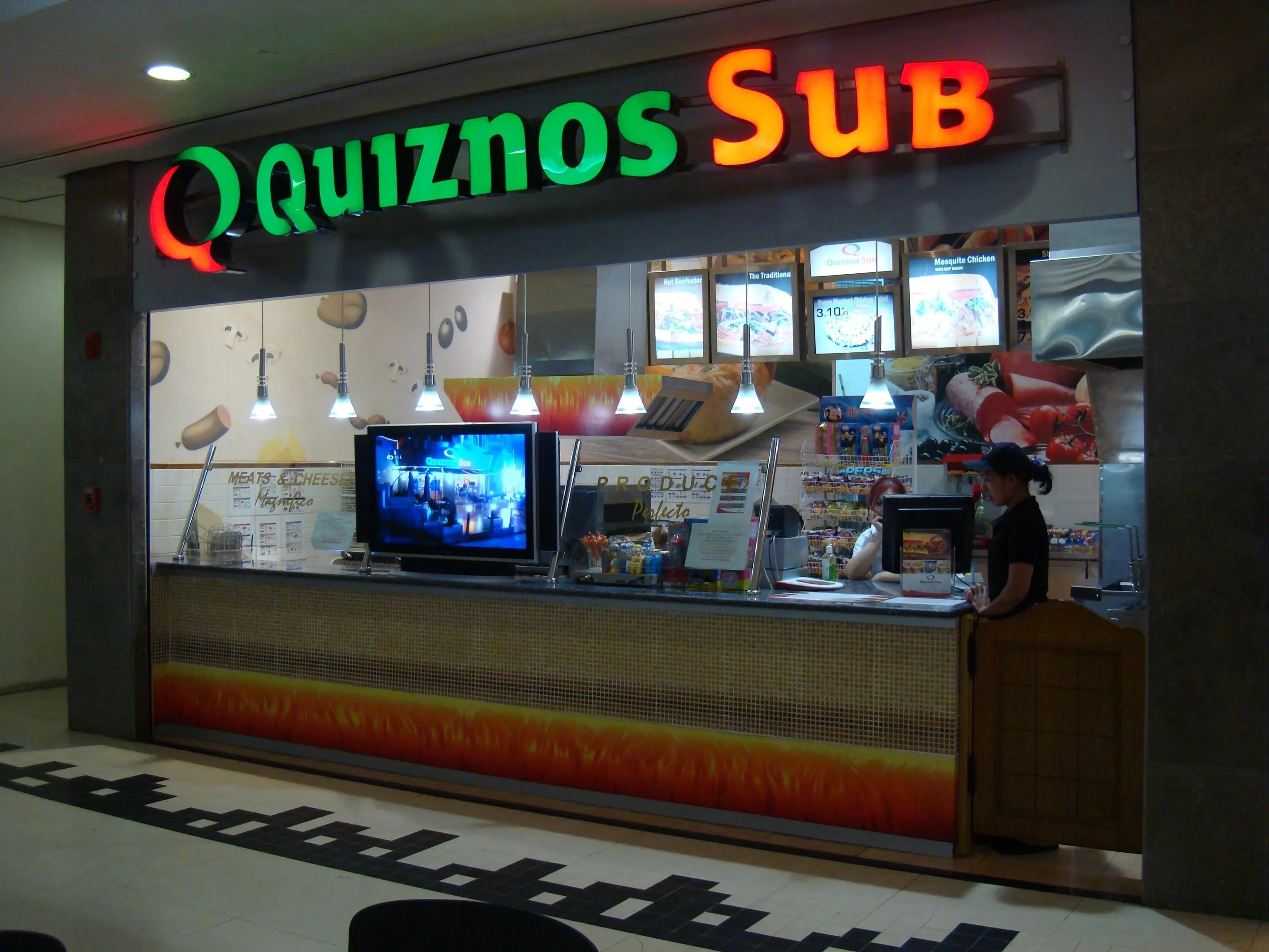 Quiznos Sub counter with illuminated sign and menu boards